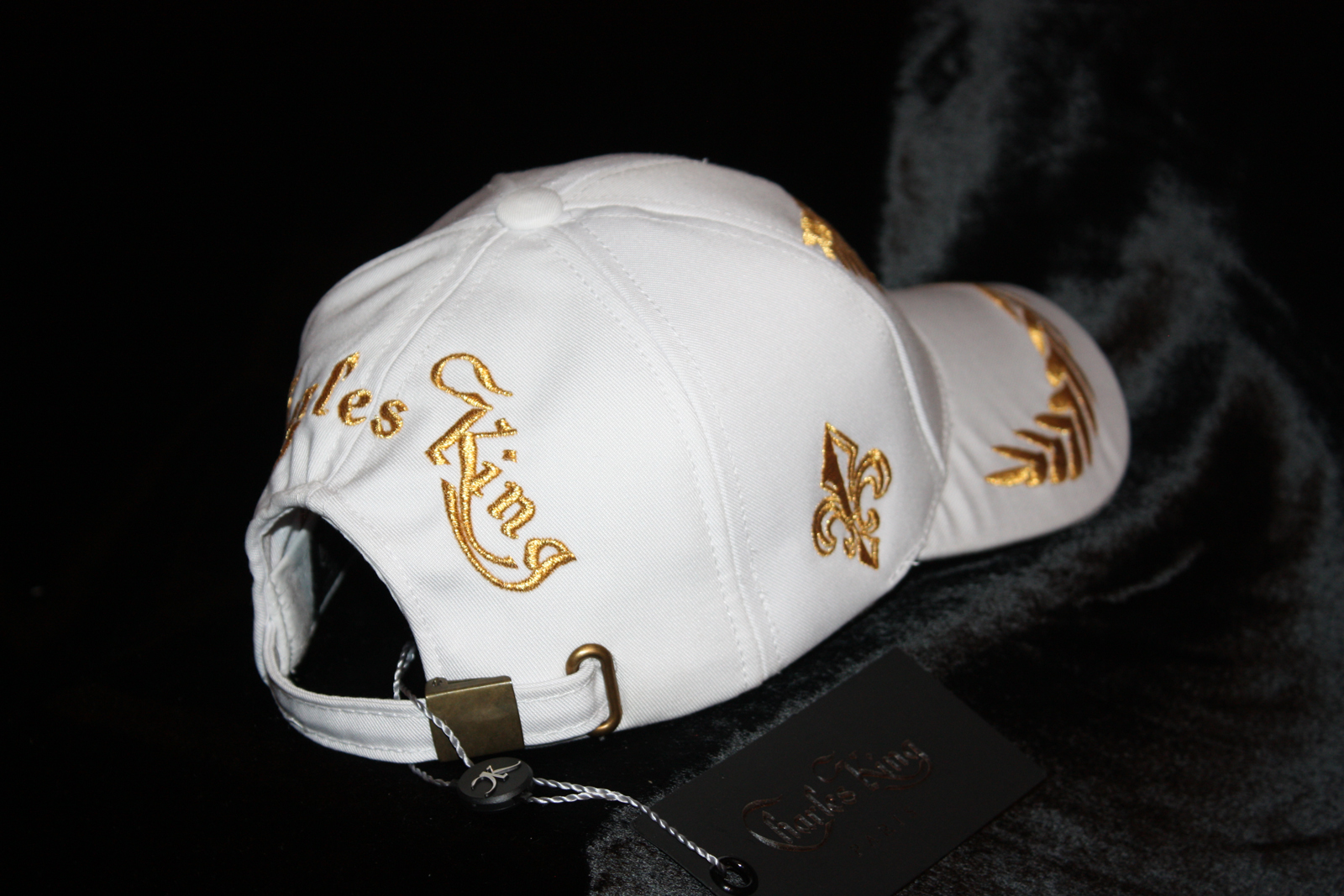 white and gold baseball cap
