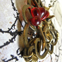 Snakes on a Goldtone Triangle Pendant