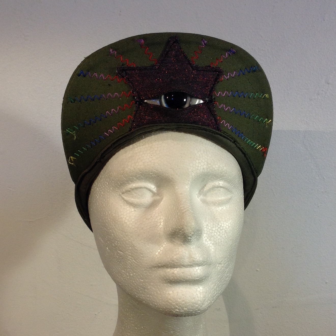 econo illuminator 004; glow in the dark eye, green cap